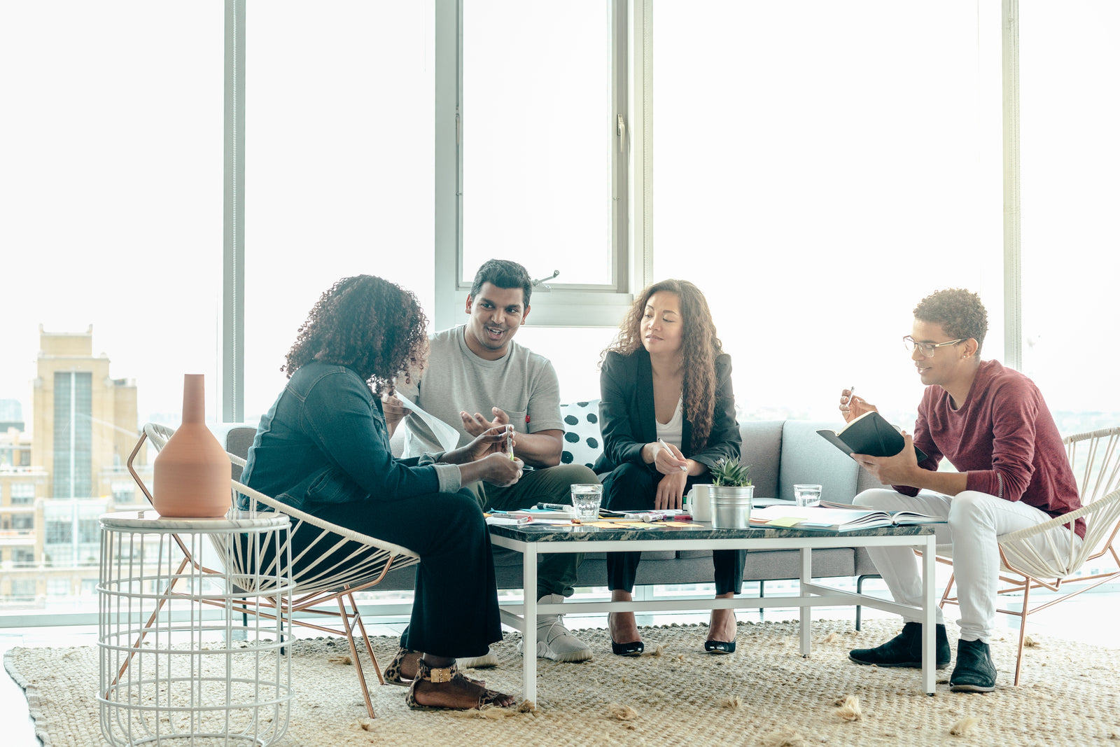Illustrative stock  -  team in a sunlit discussion. Not ReStructure AI staff or customers.